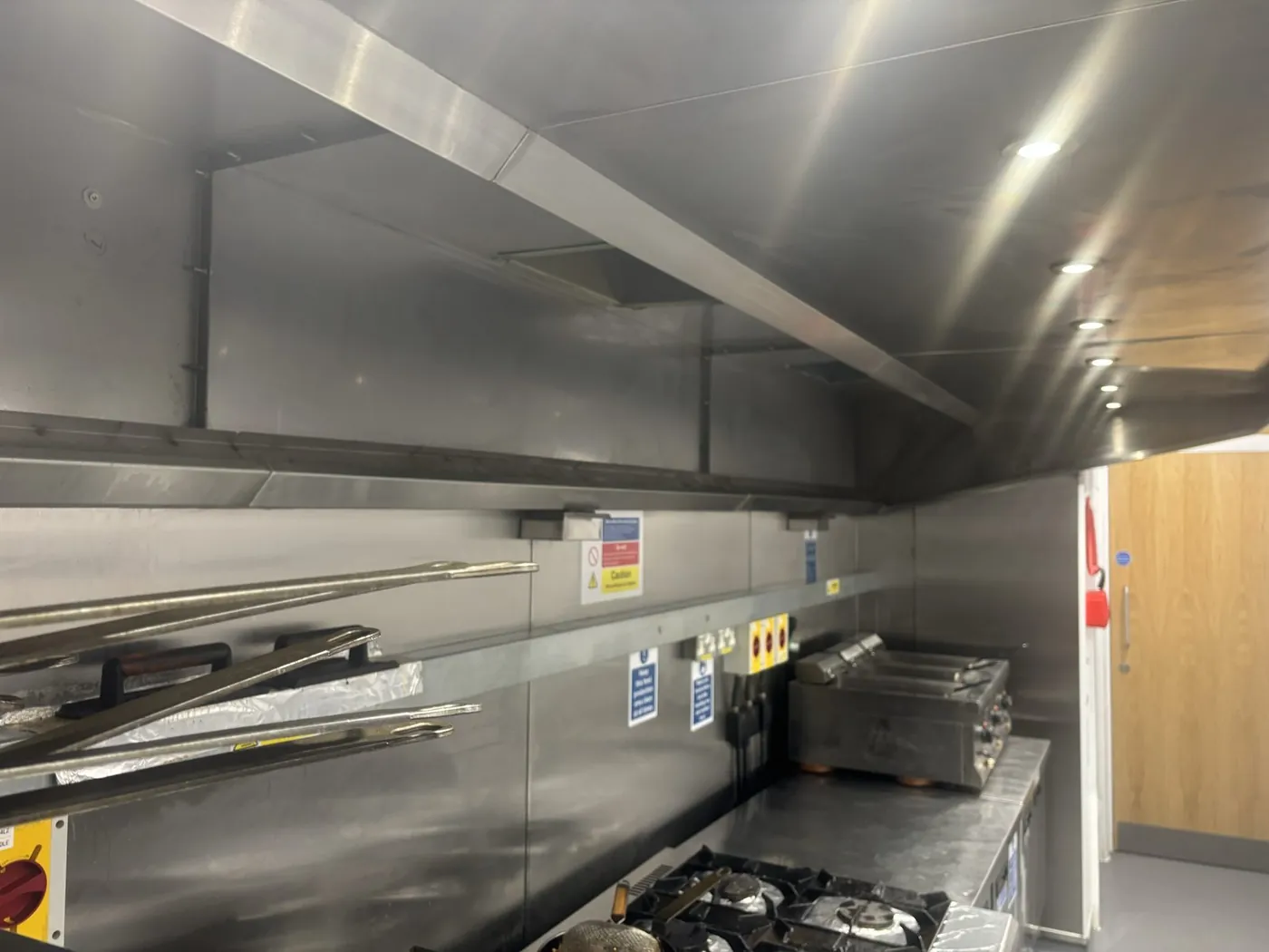 The cleaned extraction canopy above the cooking line at a pub kitchen in Neyland, Pembrokeshire
