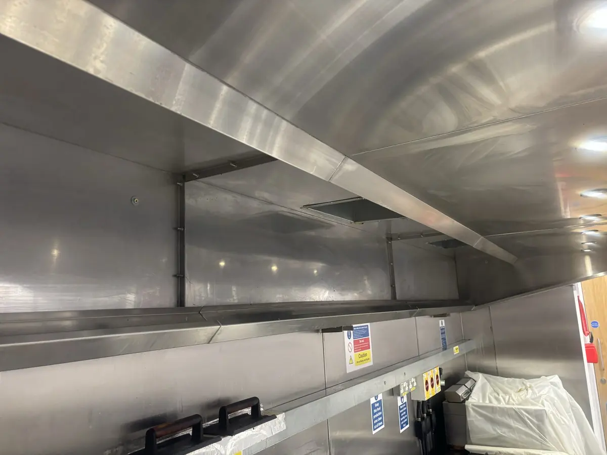 The full canopy run above the cooking line, cleaned, in a Pembrokeshire pub kitchen