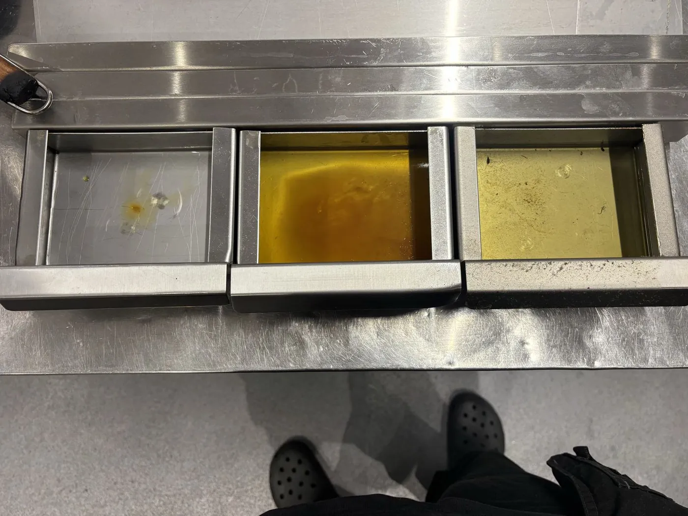 Kitchen extract filter trays, one clean and two holding accumulated grease