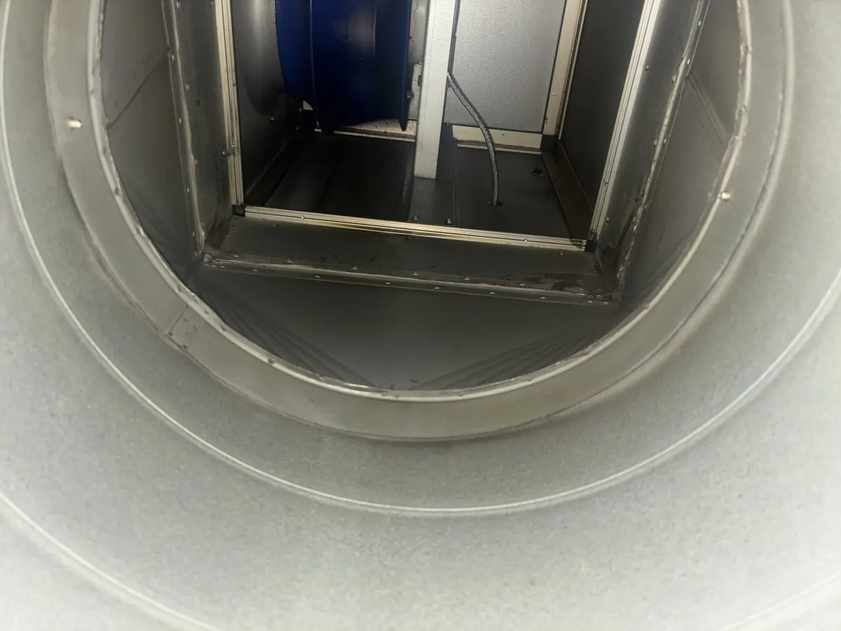 Oval discharge ductwork rising to the roof termination, cleaned